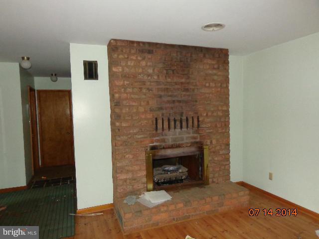 11008 Garrison Hollow Road Clear Spring, MD 21722 - Photo 5 of 30 a view of an empty room with a fireplace