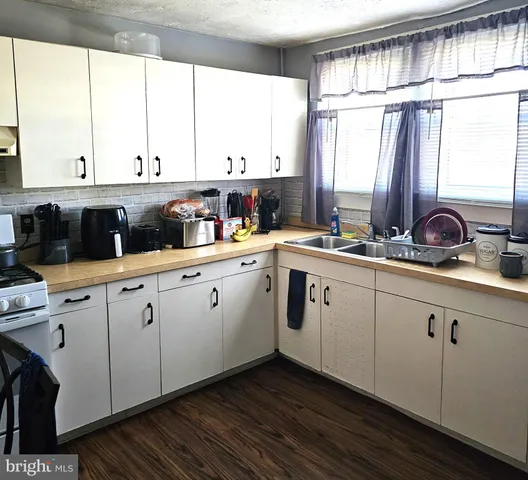 a kitchen with a sink and cabinets