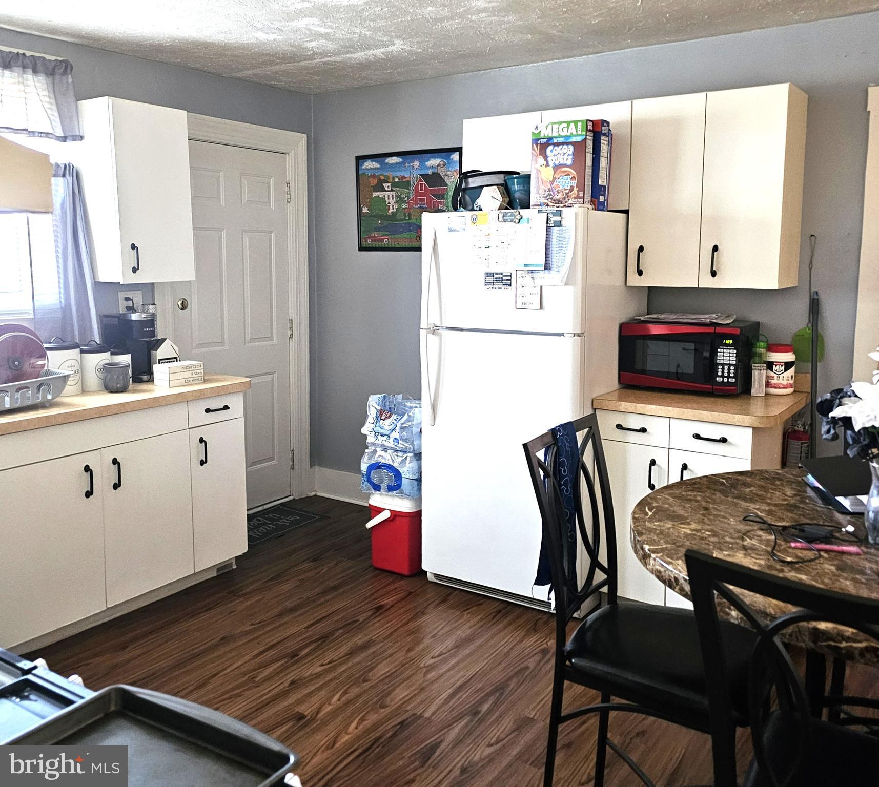 119 Maffitt Street Elkton, MD 21921 - Photo 13 of 14 a kitchen with a table chairs and a refrigerator