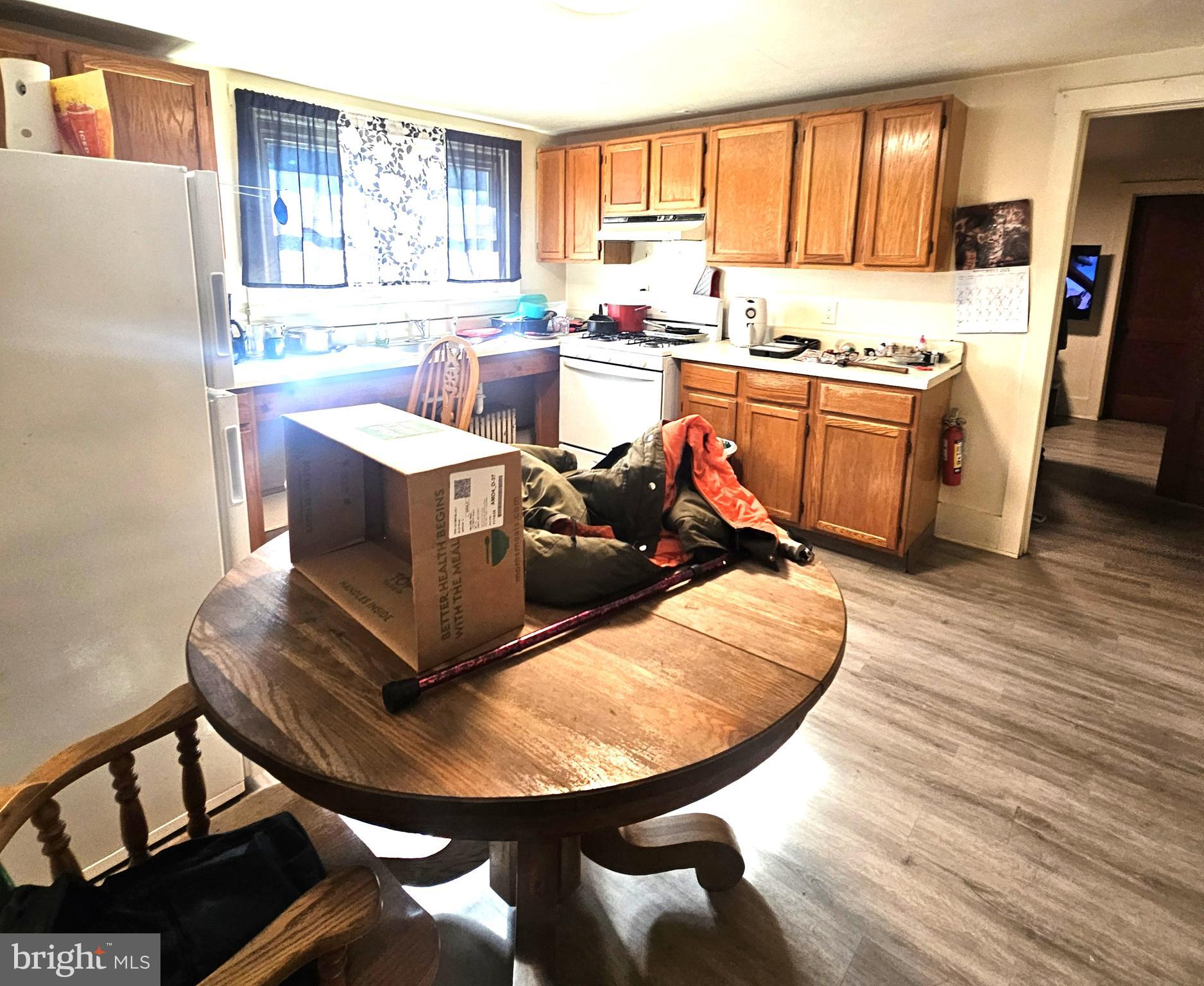 119 Maffitt Street Elkton, MD 21921 - Photo 5 of 14 a living room with stainless steel appliances furniture a kitchen view wooden floor and a window