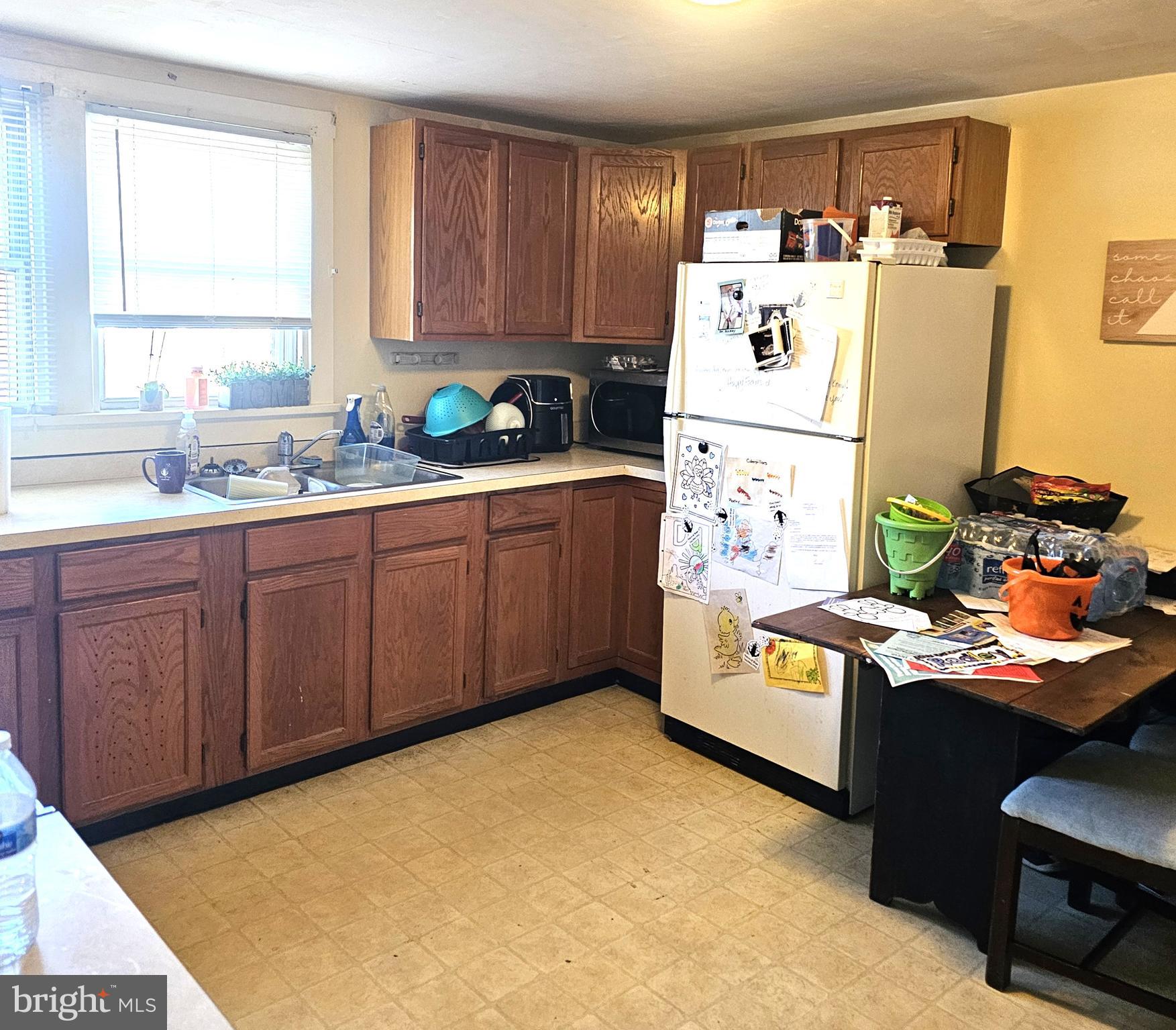 119 Maffitt Street Elkton, MD 21921 - Photo 8 of 14 a kitchen with stainless steel appliances a refrigerator a sink a stove and white cabinets