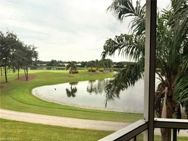 a view of a swimming pool with a garden and lake view