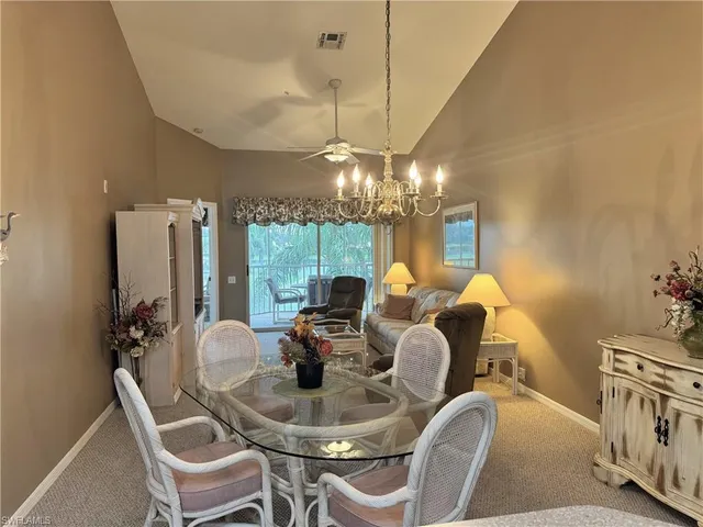 a dining room with furniture and chandelier