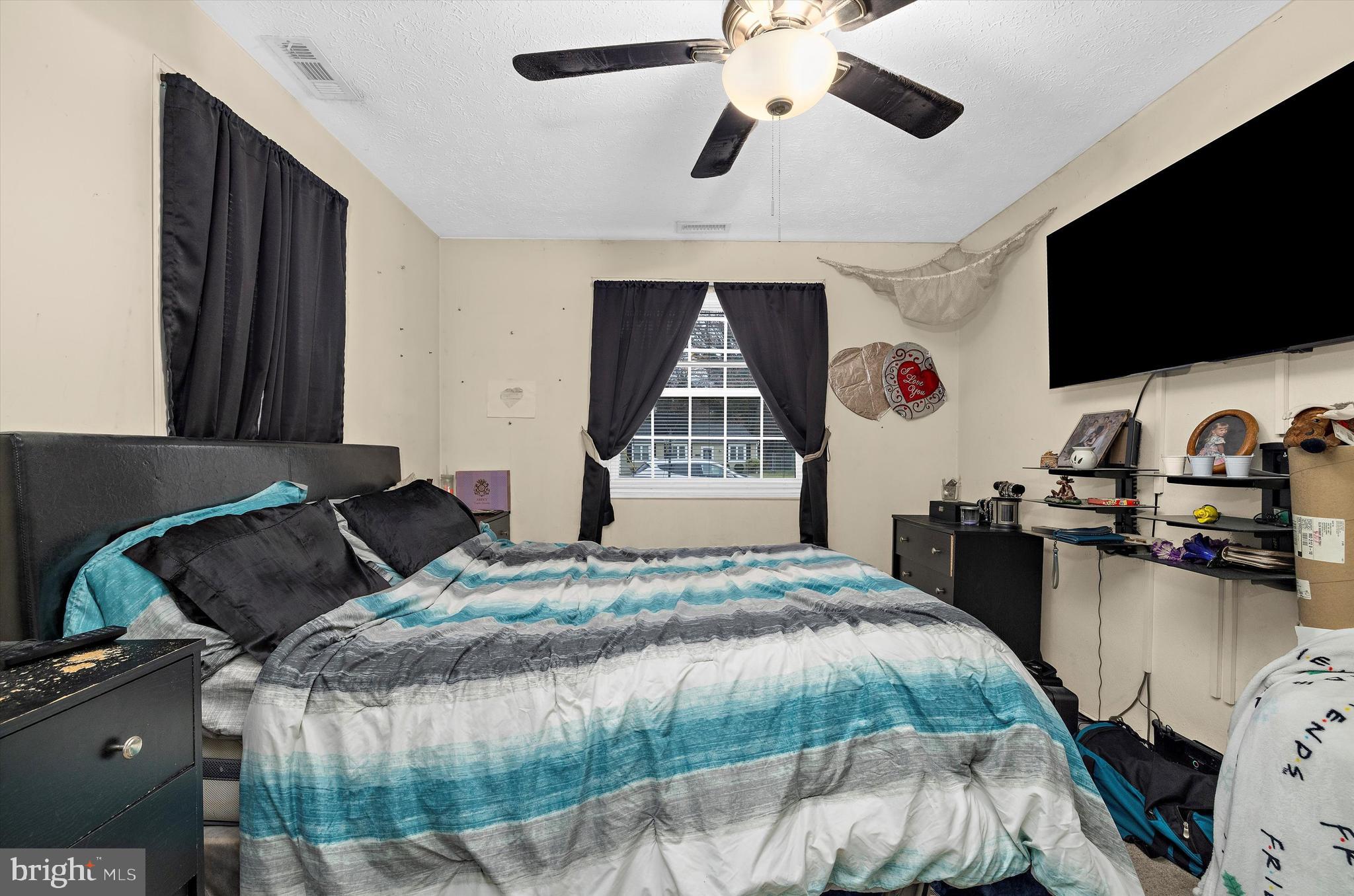 1921 Norwich Road Glen Burnie, MD 21061 - Photo 20 of 37 a bedroom with a bed window and a flat screen tv