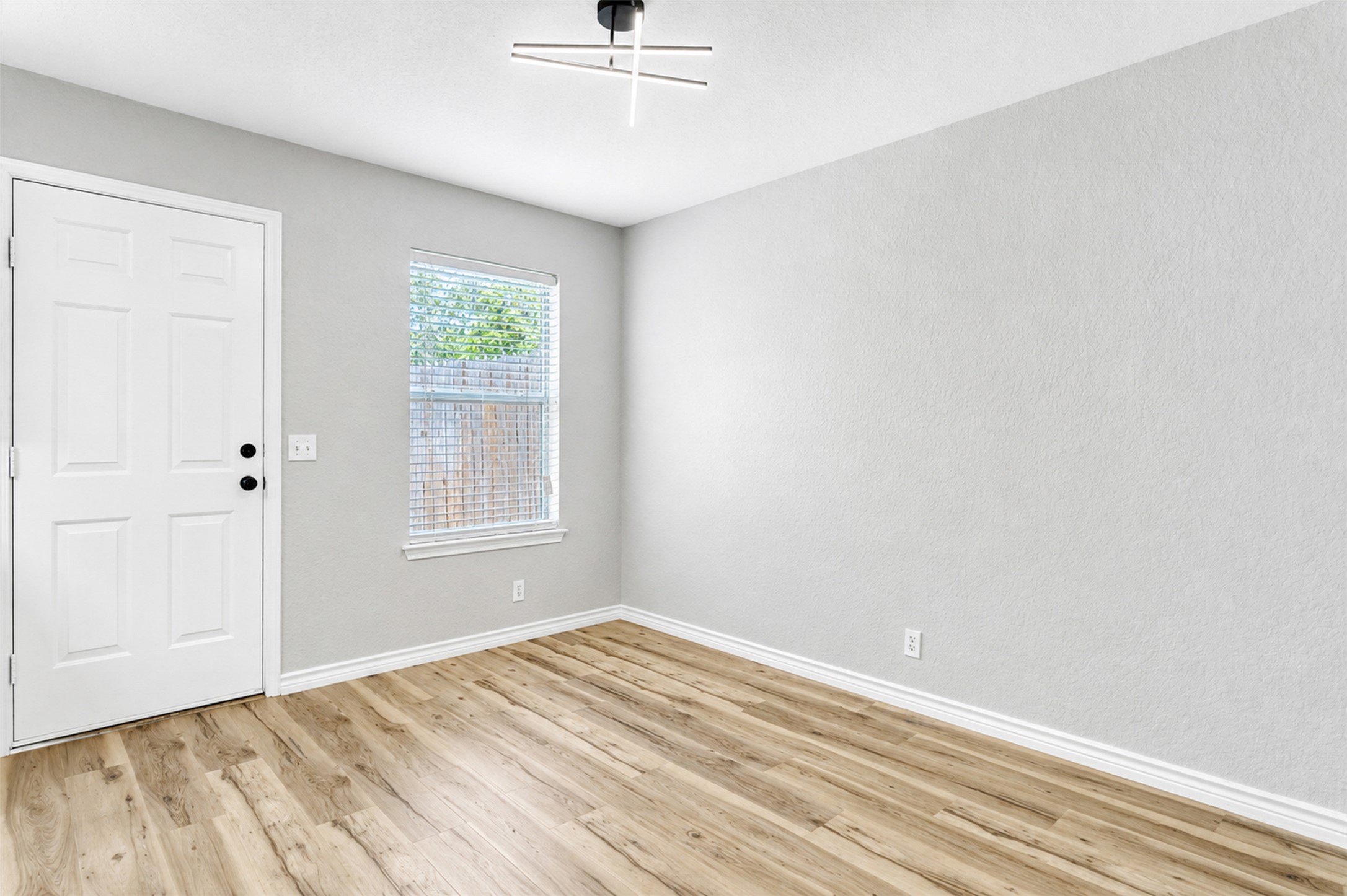 4523 Secure Lane Austin, TX 78725 - Photo 23 of 40 A versatile space features durable hardwood-style flooring and abundant natural light from a well-placed window.
