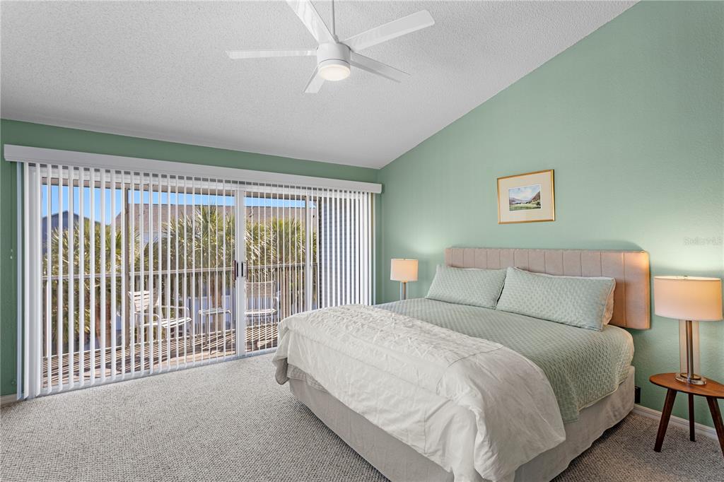 911 Harbour House Drive Indian Rocks Beach, FL 33785 - Photo 17 of 27 a bed room with a bed and a lamp
