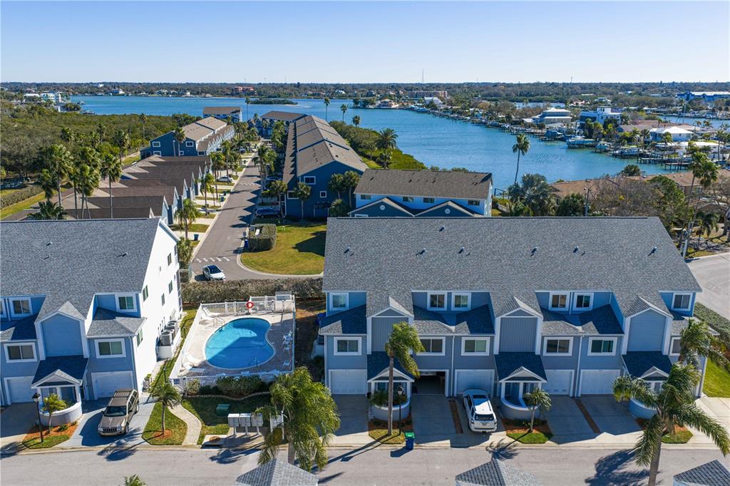 911 Harbour House Drive Indian Rocks Beach, FL 33785 - Photo 2 of 27 an aerial view of residential houses with outdoor space and parking