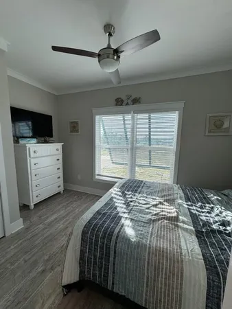 a bedroom with a bed and a flat screen tv