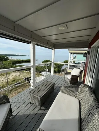 a view of a balcony with couch and wooden floor