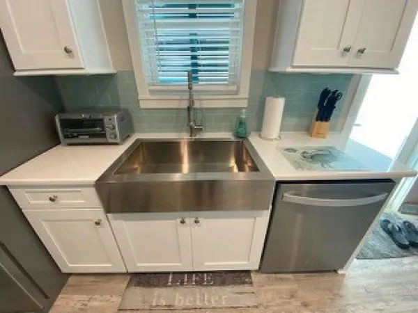a kitchen with white cabinets and a sink