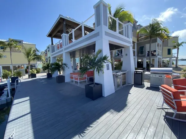 a view of the house with barbeque oven and seating space