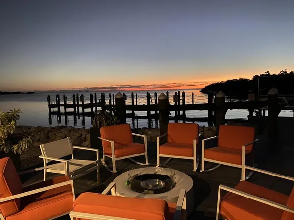 a balcony with chairs and table