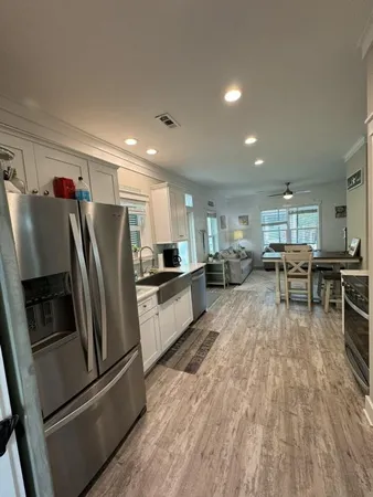 a kitchen with stainless steel appliances a refrigerator and a stove top oven