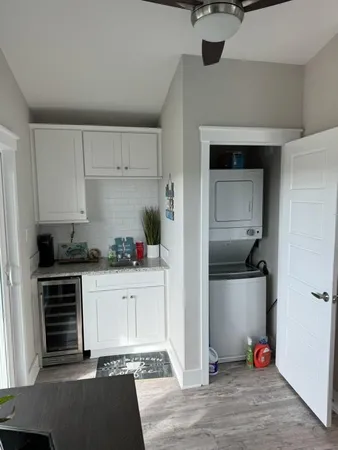 a kitchen with white cabinets and appliances