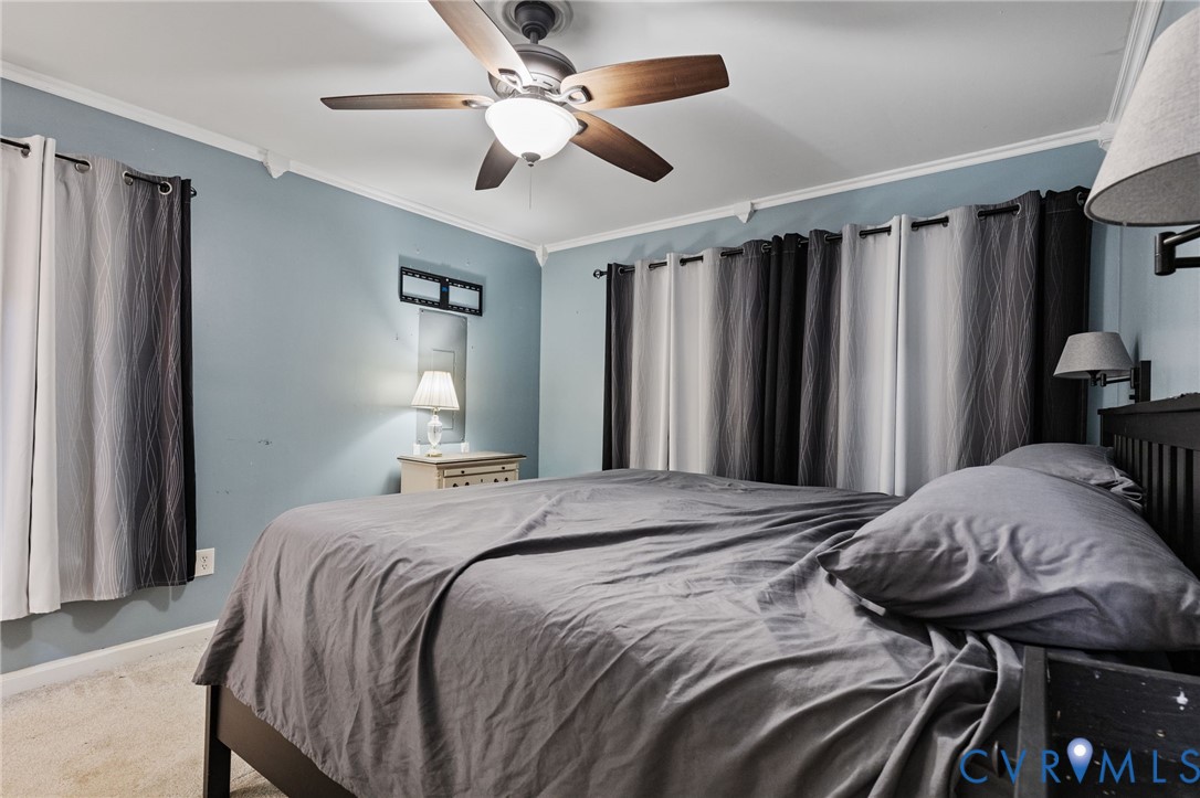 15601 Roland View Drive Chester, VA 23831 - Photo 12 of 18 a bedroom with a bed and a chandelier