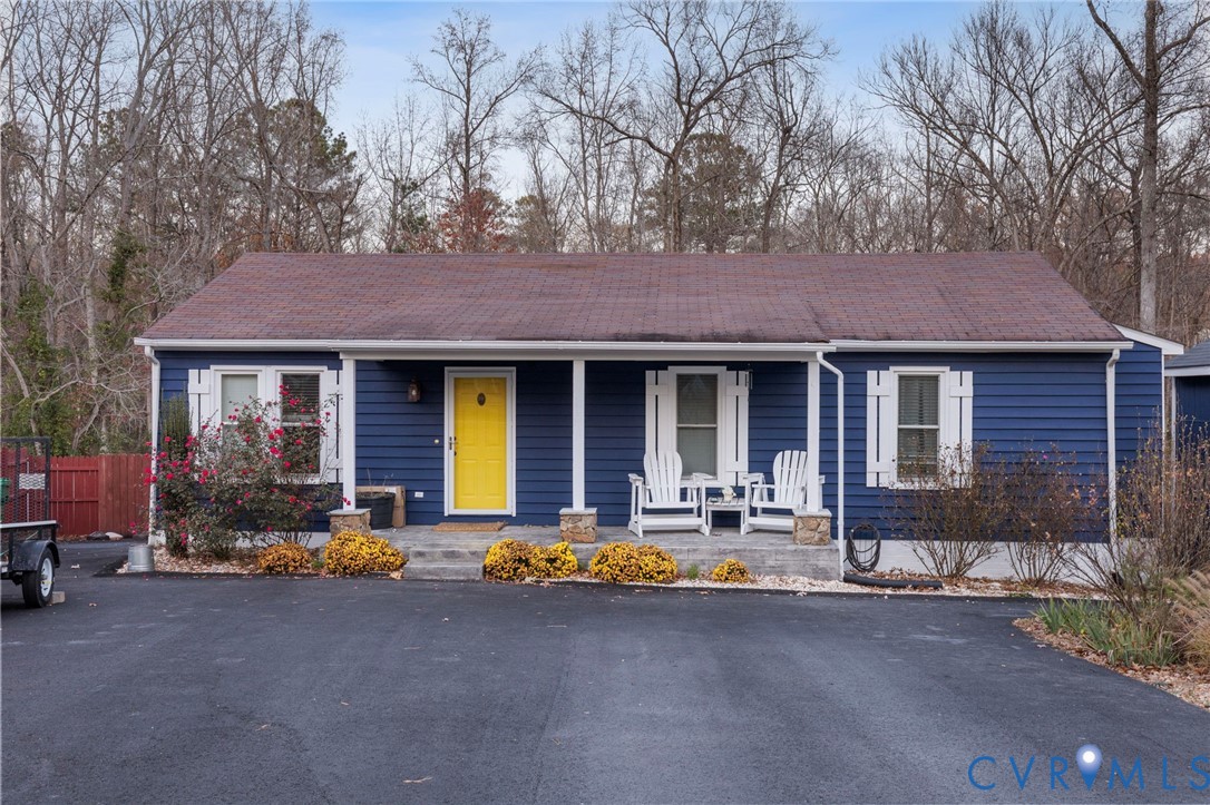 15601 Roland View Drive Chester, VA 23831 - Photo 2 of 18 a front view of a house with outdoor seating and covered with trees