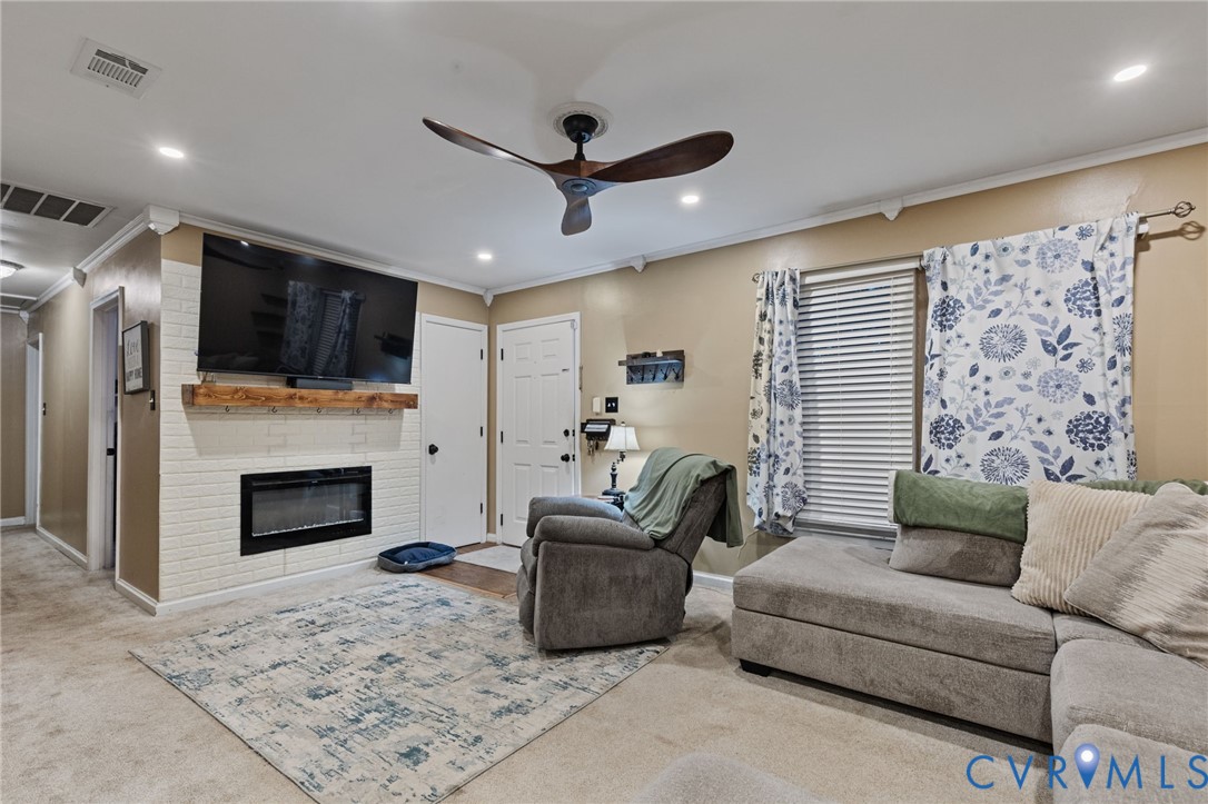 15601 Roland View Drive Chester, VA 23831 - Photo 4 of 18 a living room with furniture a fireplace and a flat screen tv