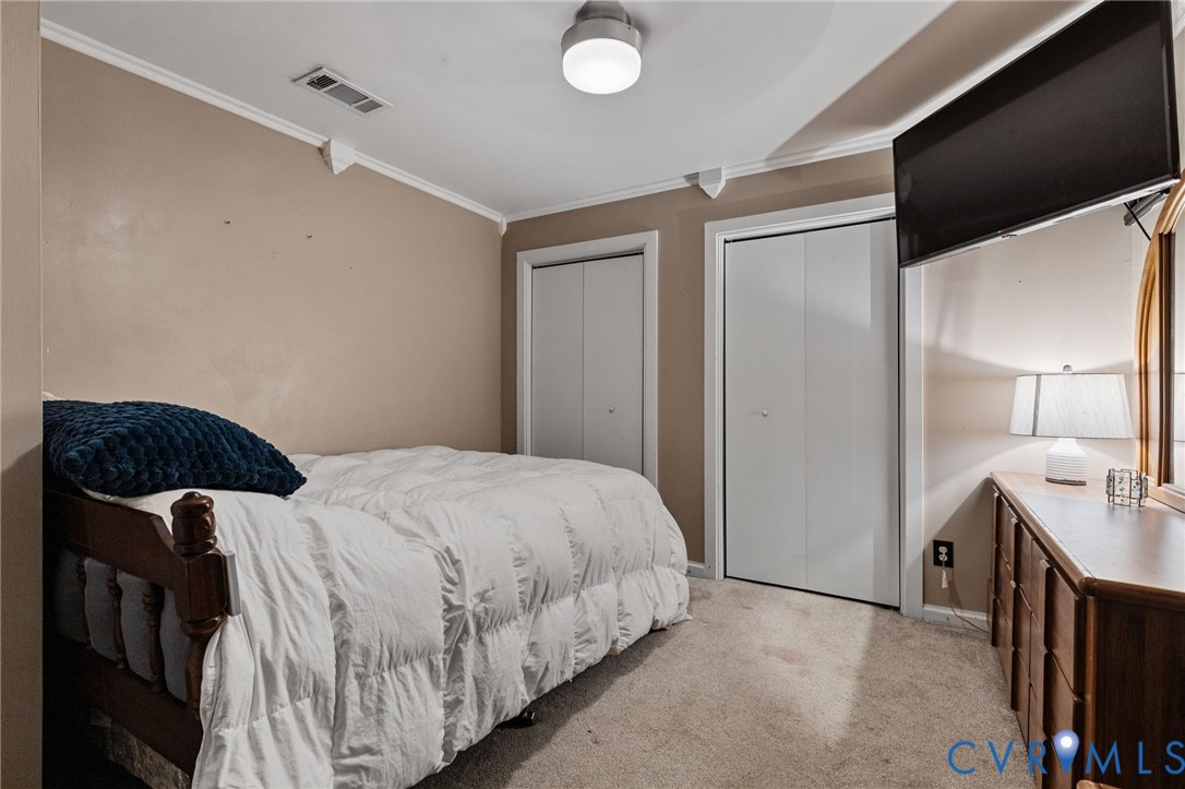 15601 Roland View Drive Chester, VA 23831 - Photo 8 of 18 a bedroom with a bed and a lamp