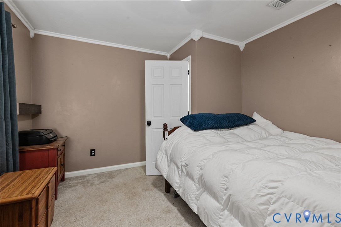 15601 Roland View Drive Chester, VA 23831 - Photo 9 of 18 a bedroom with a bed and cabinets