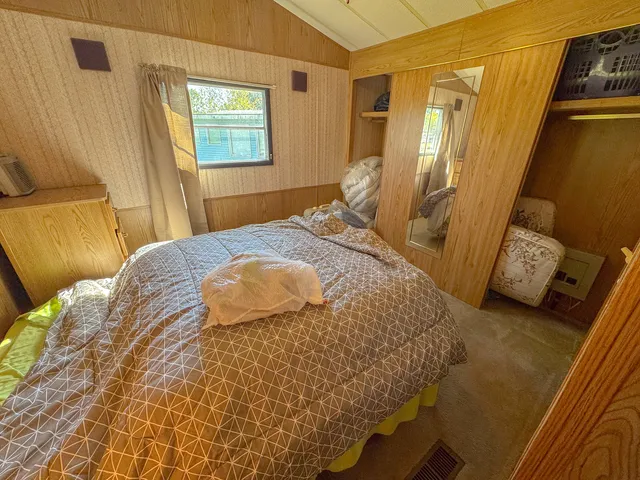 a bedroom with a bed and a window