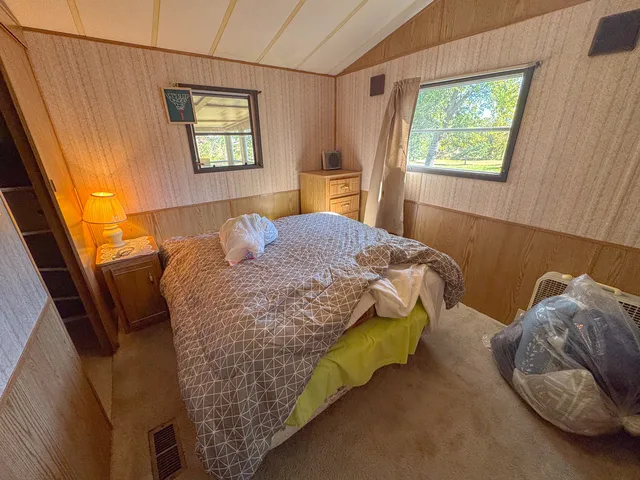 a bedroom with a bed and a window