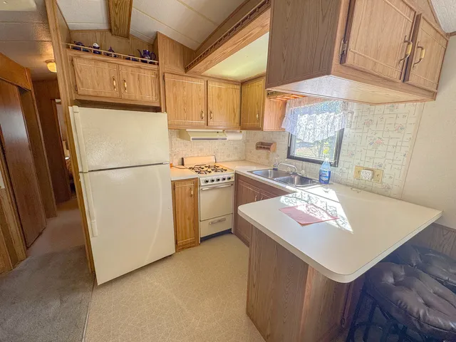 a white refrigerator freezer sitting inside of a kitchen