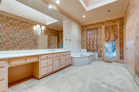 a large spacious bathroom with a large tub shower and sink