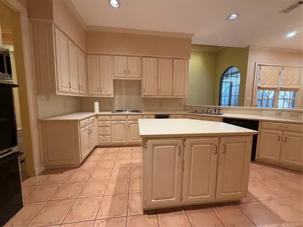 a kitchen with stainless steel appliances granite countertop a sink a stove a refrigerator a microwave and cabinets