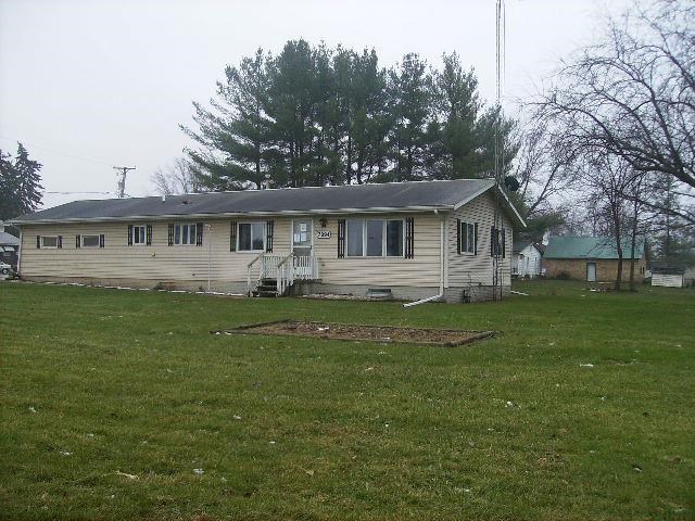 7994 Freeport Road Rockton, IL 61072 - Photo 1 of 3 a front view of a house with a yard table and chairs