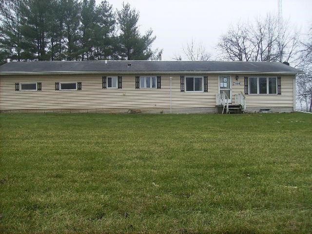 7994 Freeport Road Rockton, IL 61072 - Photo 3 of 3 a front view of a house with a garden