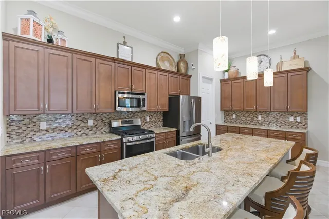 a kitchen with stainless steel appliances granite countertop a sink refrigerator and microwave