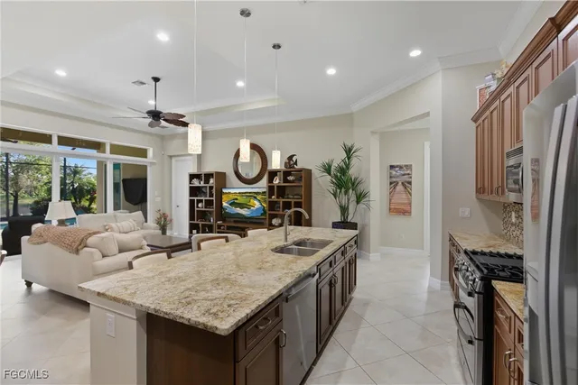 a dining hall with stainless steel appliances granite countertop a kitchen island a stove a refrigerator a oven and a refrigerator