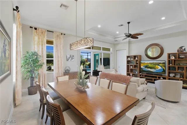 a view of a dining room with furniture and a large window