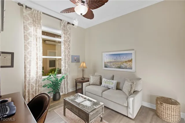 a living room with furniture potted plant and a window
