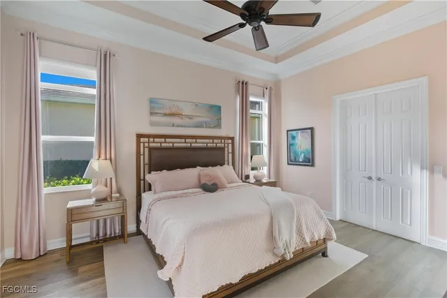a bedroom with a large bed and a chandelier