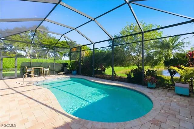 an aerial view of residential houses with outdoor space and ocean view