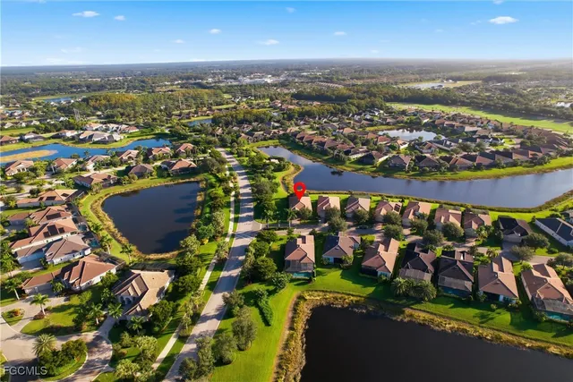 an aerial view of a house with a lake view
