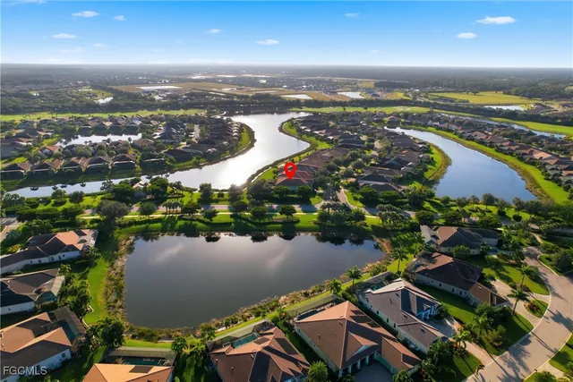 an aerial view of residential houses with outdoor space and trees