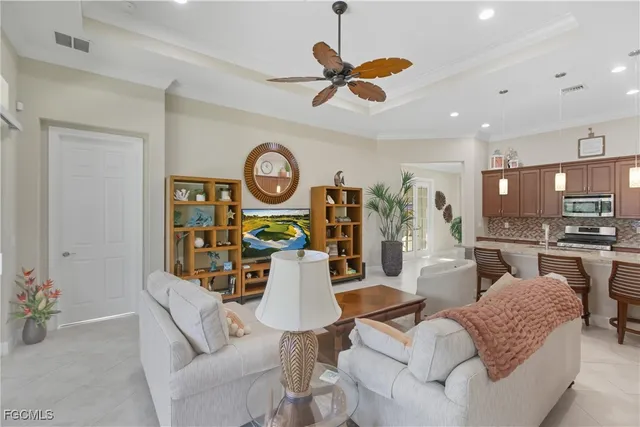 a living room with furniture a rug and kitchen view
