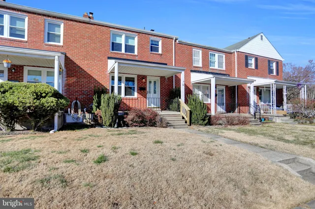 a front view of a building with trees