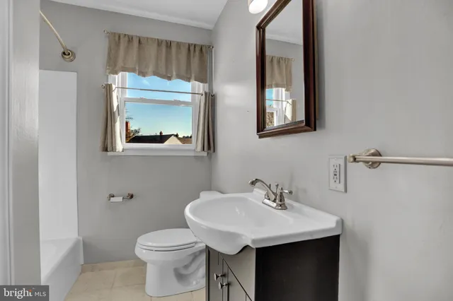 a bathroom with a sink toilet and mirror