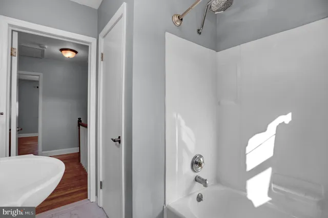 a bathroom with a tub and shower