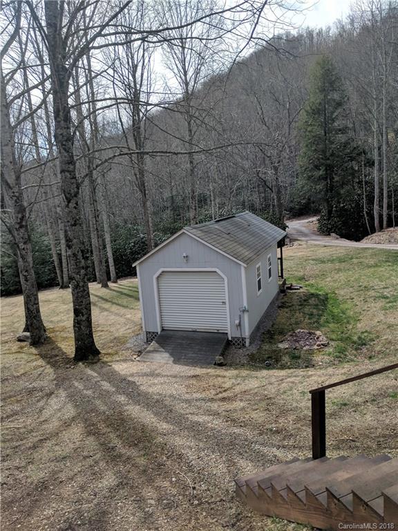 370 Quail Cove Road Clyde, NC 28721 - Photo 22 of 23 a view of a barn in the middle of a yard