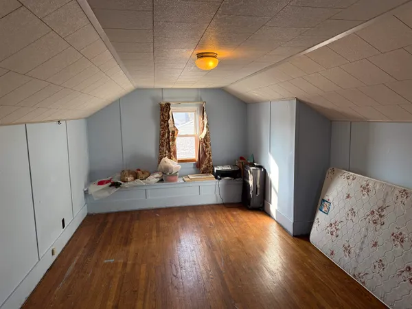 a room with wooden floors and a window