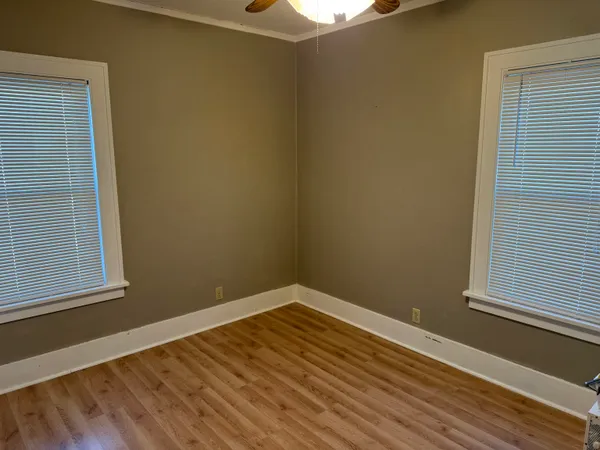 a view of a room with wooden floor and a window