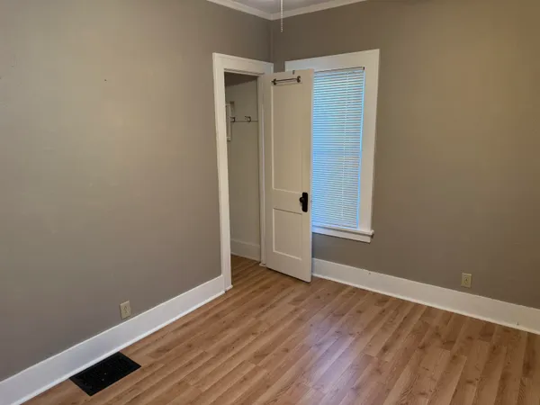 a view of an empty room with wooden floor