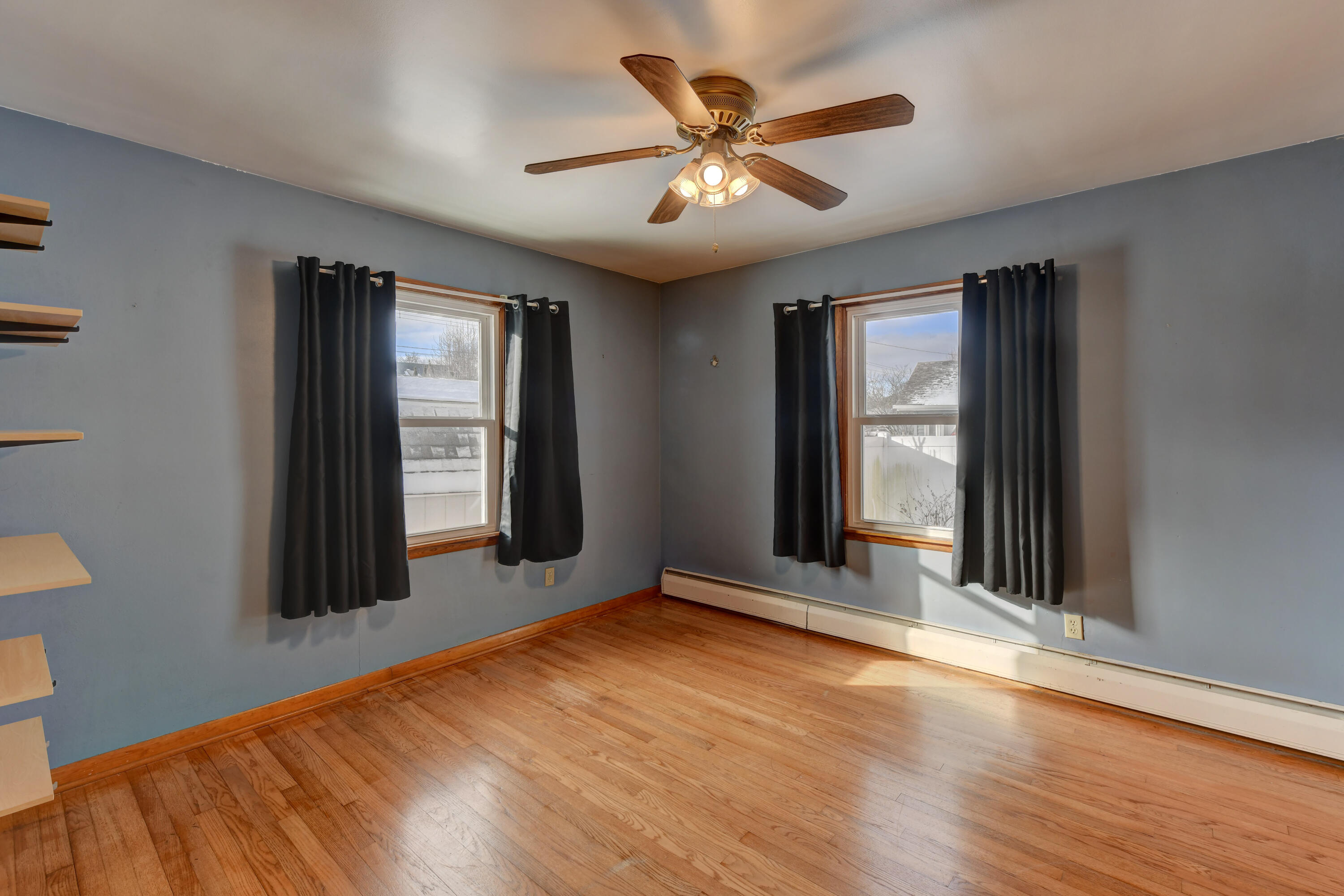 9046 Kleinman Road Highland, IN 46322 - Photo 14 of 20 an empty room with wooden floor chandelier and windows