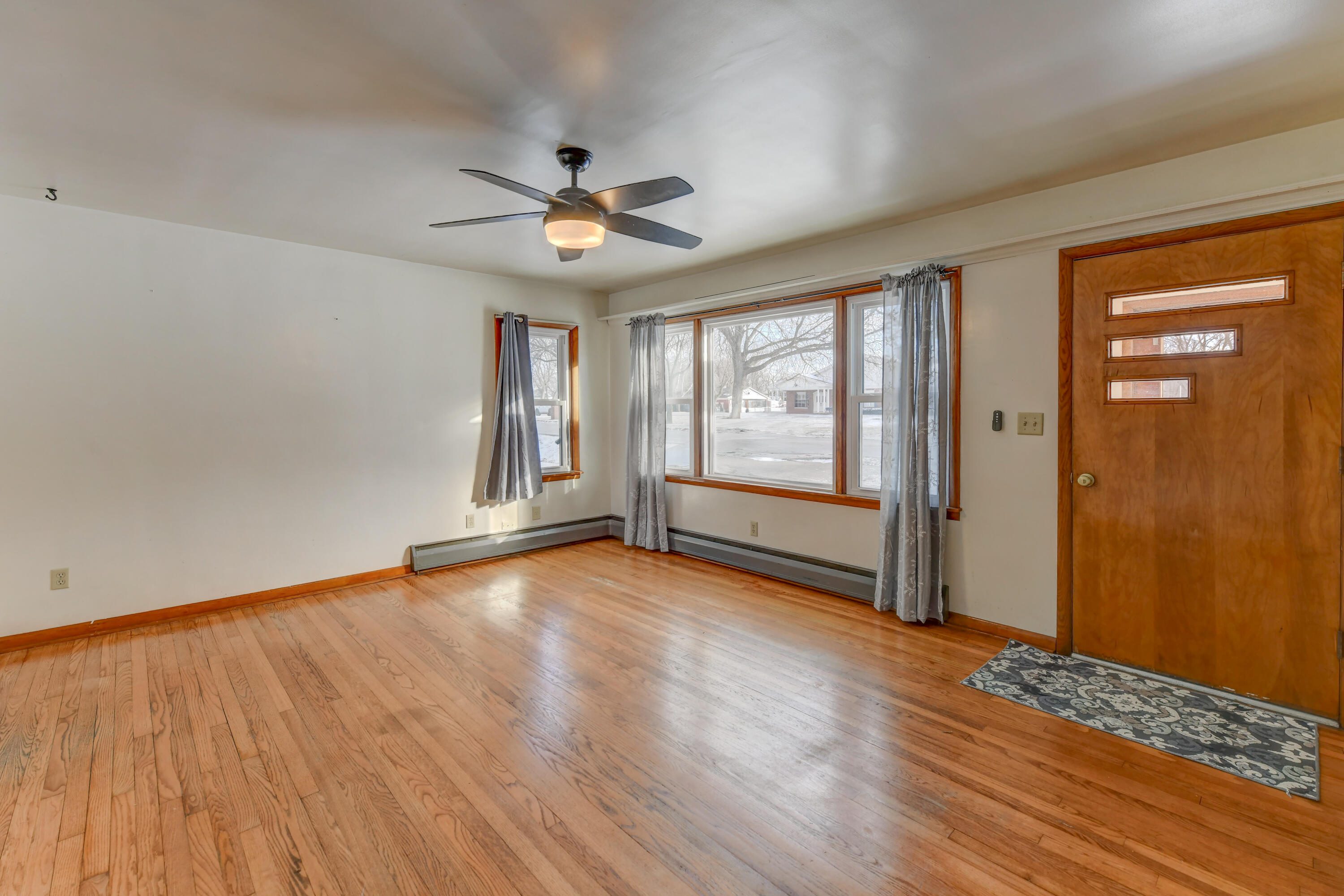 9046 Kleinman Road Highland, IN 46322 - Photo 4 of 20 an empty room with wooden floor and windows