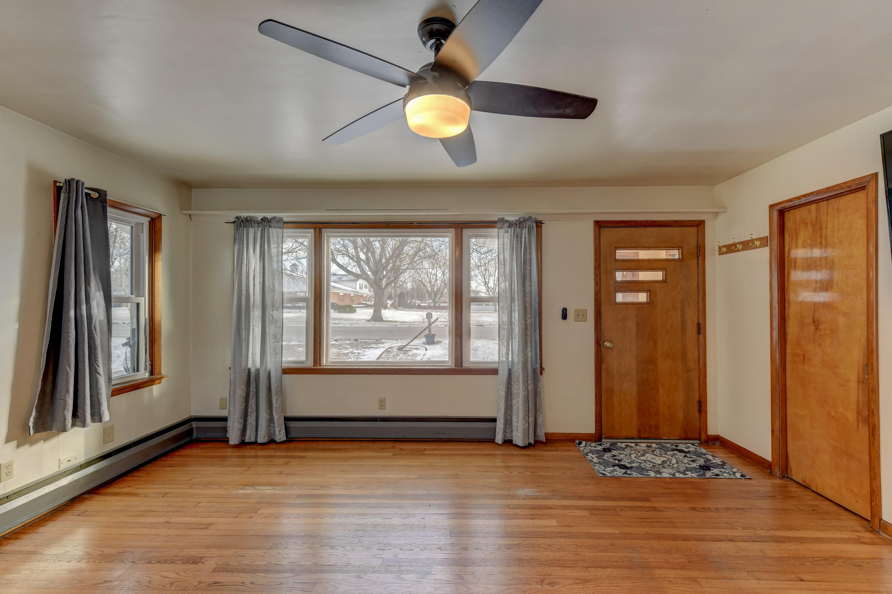 9046 Kleinman Road Highland, IN 46322 - Photo 5 of 20 an empty room with wooden floor and windows