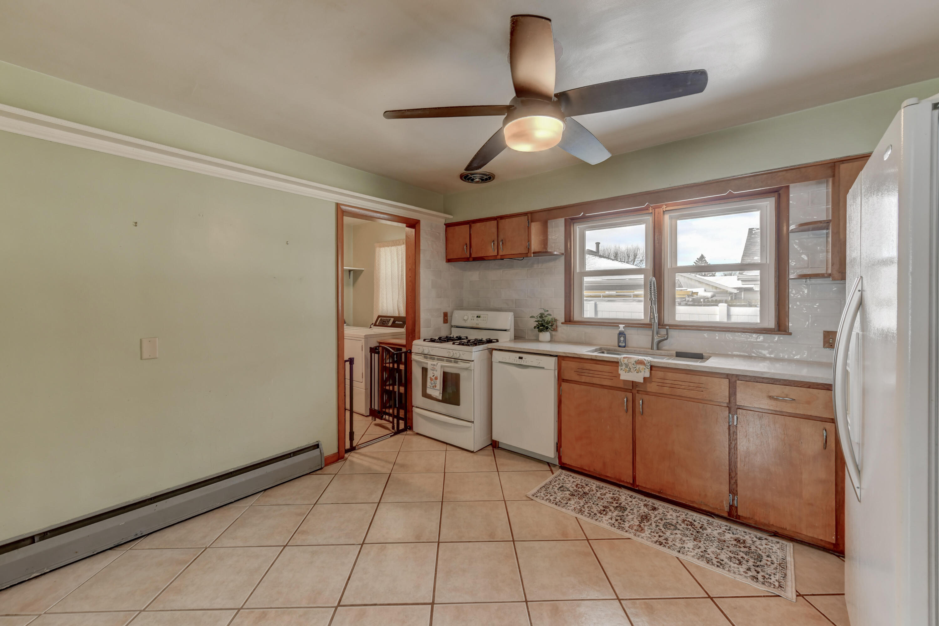 9046 Kleinman Road Highland, IN 46322 - Photo 7 of 20 a kitchen with stainless steel appliances granite countertop a sink window and cabinets